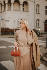 a lady in an asymmetrical top and a brown tulle skirt